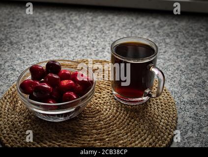Some fresh cherries from own garden withe a cub of coffe. Stock Photo
