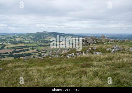 View from Titterstone Clee Hill looking towards Brown Clee Hill on 22nd July 2020 in Cleedownton, United Kingdom. Titterstone Clee Hill, sometimes referred to as Titterstone Clee or, incorrectly, Clee Hill, is a prominent hill in the rural English county of Shropshire, rising at the summit to 533 metres above sea level. It is one of the Clee Hills, in the Shropshire Hills Area of Outstanding Natural Beauty. Most of the summit of the hill is affected by man-made activity, the result of hill fort construction during the Bronze and Iron Ages and, more recently, by years of mining for coal and qua Stock Photo