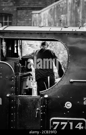 Mono steam train crew fireman filling vintage steam locomotive with ...