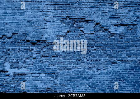 Old brick wall texture close up toned in blue. Top view. Brick wall wallpaper design for web or graphic art projects. Top view. Trendy Banner with col Stock Photo