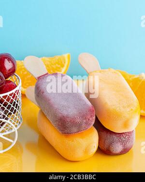 A fruit ice cream and small basket with cherry, slice of orange . Summer time Stock Photo