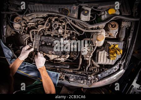 Job and workplace concept, mechanic in a workshop repairing a car Stock Photo