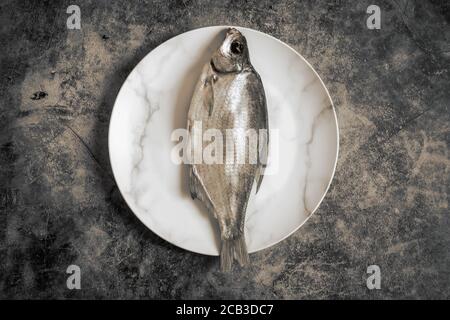 Salted and dried fish on a plate Stock Photo