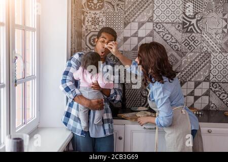 crazy parents entertaining their lovely child, close up photo. happiness, positive emotion, feeling Stock Photo