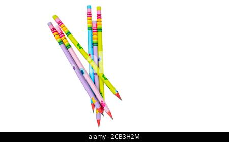 Bunch of pencils of different colors with stickers gathered in a row on a white paper background Stock Photo