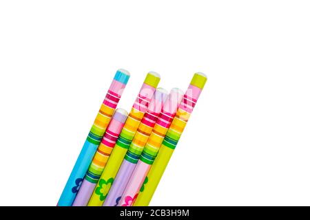 Pencil of different colors with stickers gathered in a row on a white paper background Stock Photo