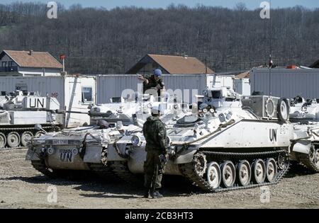 30th March 1994 During the war in Bosnia: a British Army FV103 Spartan APC of the Light Dragoons Regiment parked next to FV107 Scimitar fighting vehicles inside the British base in Bila, near Vitez. Stock Photo