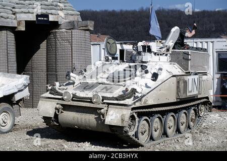 30th March 1994 During the war in Bosnia: a British Army FV103 Spartan APC of the Light Dragoons Regiment parked next to a bomb shelter inside the British base in Bila, near Vitez. Stock Photo