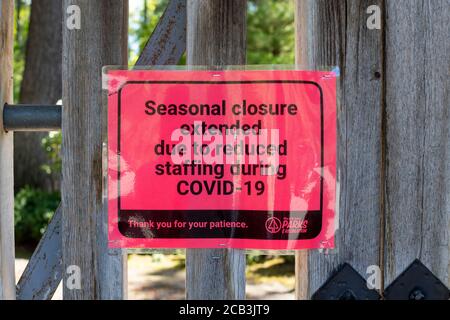 A Seasonal Closure sign is posted on a wooden gate due to the COVID-19 virus in Spokane, Washington, USA Stock Photo