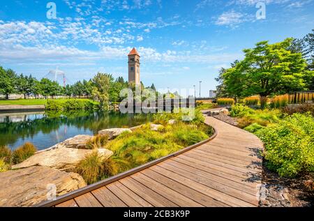 Summer day along the Spokane River in Riverfront Park with the Clock Tower, Pavilion and walking path in view. Stock Photo