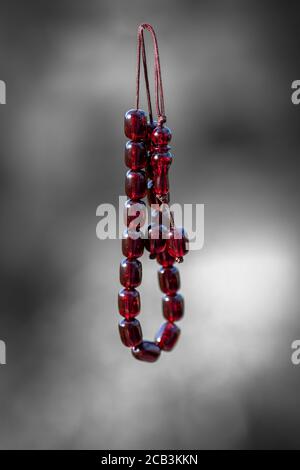 Greek worry beads. Amber greek traditional rosary on blurry background. Komboloi, orthodox rosary used frequently by men. Stock Photo