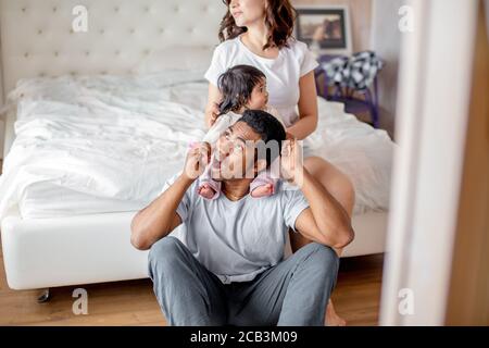 funny daddy trying to bite his daughter's sweet hands, close up photo. entertainmnet concept Stock Photo