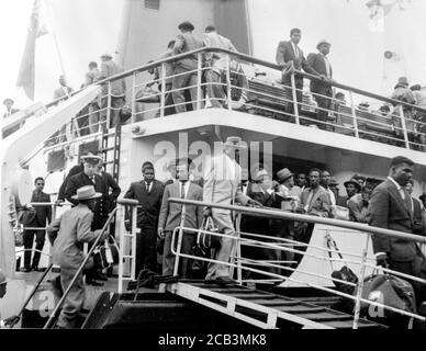 Men, women and children from the Caribbean arrive at Southampton in 1962 at the invitation of the British Government to help with rebuilding Britain after World War II. These people became the Windrush Generation due to their treatment by the British Home Office under a hostile environment policy where employers and other organisations were required to ask for visas.