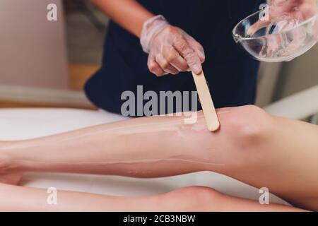 Beautician Giving Epilation Laser Treatment To Woman On Thigh. Stock Photo