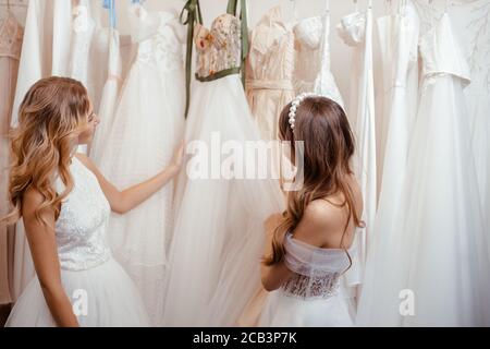 young women choosing wedding dress 