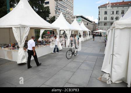 Sarajevo, Bosnia and Herzegovina (BiH). 10th Aug, 2020. People attend a book fair at Children's Square in Sarajevo, Bosnia and Herzegovina (BiH), on Aug 10, 2020. The Book Fair opened in the open space at the Children's Square in Sarajevo on Aug. 07. and will run until August 19. Credit: Nedim Grabovica/Xinhua/Alamy Live News Stock Photo