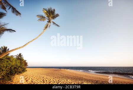 Retro toned picture of an empty tropical beach at sunset. Stock Photo