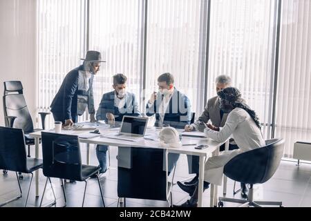 Diverse employees disputing engaged in teambuilding activity during Indian business mentor or coach presentation, multiethnic colleagues participate i Stock Photo