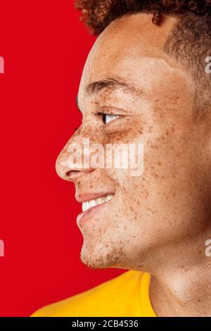 Young adult man looking away and smiling wide Stock Photo