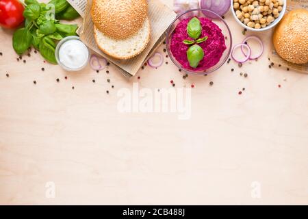 Top view ingredients for cooking vegan burgers on light wooden background with copy space flat lay. Stock Photo