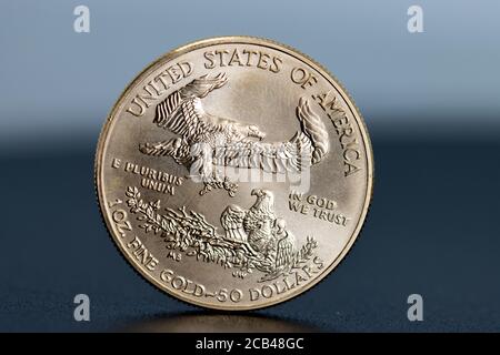 a close-up of a single gold dollar weighing one ounce Stock Photo