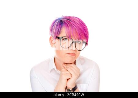 Lack of confidence. Shy young woman feels awkward isolated on white wall background. Millennial model with pink magenta hair. Human emotions, face exp Stock Photo