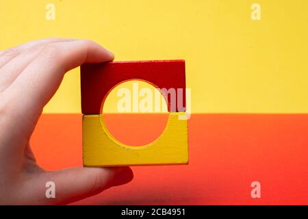 hand  building tower with colorful building blocks Stock Photo