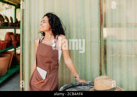 Young female saleswoman smiling at the door of a ceramic business Stock Photo
