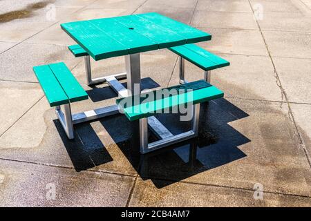 Square Wood Picnic Table Dining Table Set with 4 Bench Seats at Outdoor Picnic area Stock Photo