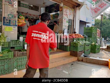 Delhi, India, 2020. Gurgaon based Zomato, Food Delivery Boy picking order from a restaurant. Online food delivery startup in the food-tech space acqui Stock Photo