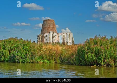 Remains of St Benet's Abbey and windmill on the banks of the River Bure, Norfolk Broads, Norfolk. Stock Photo