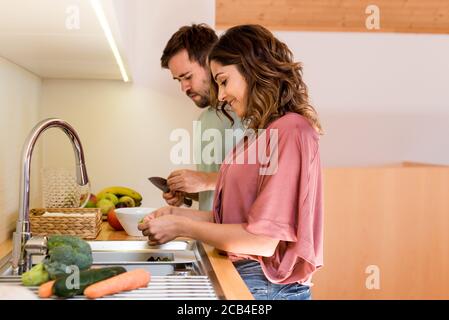 Young couple chilling out while preparing the lunch Stock Photo