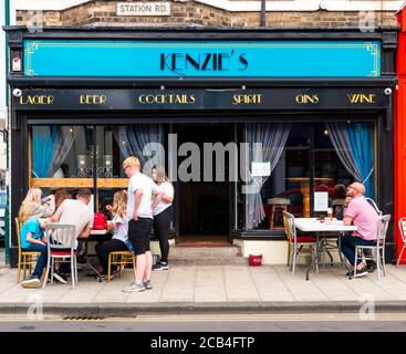 Customers enjoying summer sunshine alfresco outside Kenzies café  bar in Station Road Redcar Cleveland North Yorkshire Stock Photo