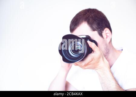 Closeup of a young man holding a camera Stock Photo