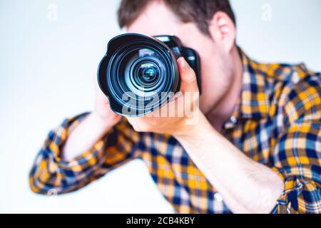 Closeup of a young man holding a camera Stock Photo