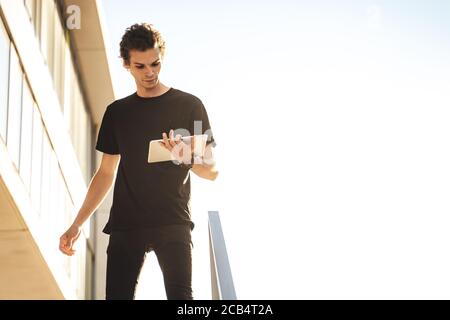 Businessman watching presentation on digital tablet outside workplace against clear sky Stock Photo