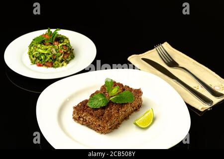 delicious baked kibe on a bronco dish photographed in a black background Stock Photo