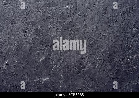 Pattern of old dark gray decorative plaster on the wall Stock Photo