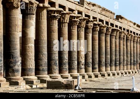 The stone columns of the west colonnade at the outer temple court at Philae (Agilqiyya Island) at Aswan in Egypt. It is also known as Temple of Isis. Stock Photo