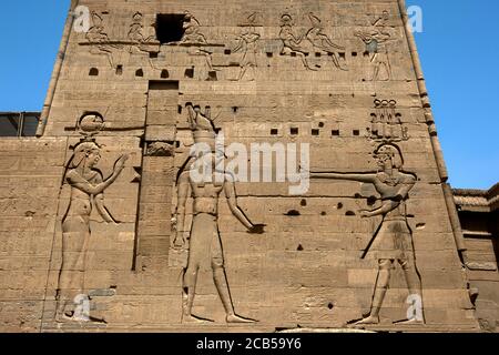 Magnificent reliefs and hieroglyphs on the second pylon at the Temple of Isis at Philae (Agilqiyya Island) at Aswan in Egypt. Stock Photo