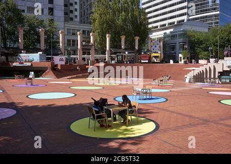Colorful social distancing circles in Portland's Pioneer Courthouse Square, seen on Wednesday, August 5, 2020, during a pandemic summer. Stock Photo