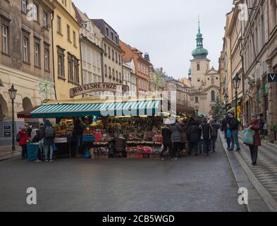 Prague, Czech Republic, December 12, 2019: Tourist people shopping at traditional christmas Market, Havelska trznice street with stalls selling gifts Stock Photo