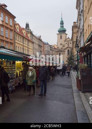 Prague, Czech Republic, December 12, 2019: Tourist people shopping at traditional christmas Market, Havelska trznice street with stalls selling gifts Stock Photo