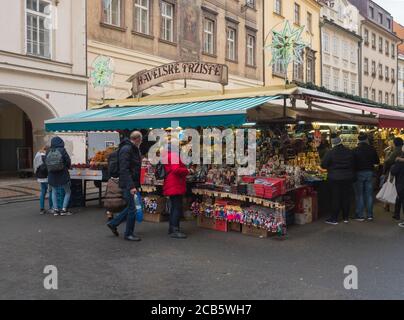 Prague, Czech Republic, December 12, 2019: Tourist people shopping at traditional christmas Market, Havelska trznice street with stalls selling gifts Stock Photo