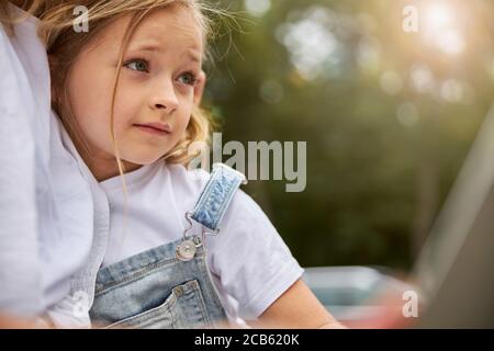 Good young girl sitting near the woman Stock Photo