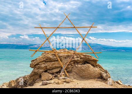 Wooden Shield of David (Magen David or Star of David) with the Dead Sea in the background