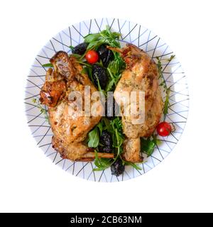 Baked rabbit with prunes on a plate isolated on white. Diet menu. Proper nutrition. Stock Photo