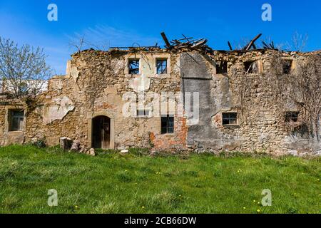 The facade of a ruined, almost broken down farmers house Stock Photo