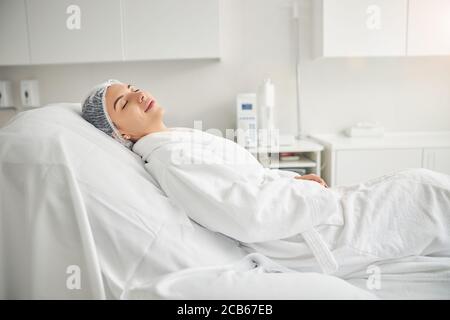 Calm spa client relaxing before a cosmetic procedure Stock Photo