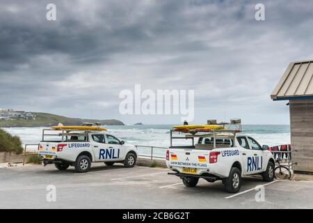 Two RNLI Emergency response vehicles parked in a car park overlooking Fistral Beach in Newquay in Cornwall. Stock Photo